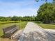 Picturesque bocce ball court with scenic views of the lake and lush greenery, with benches nearby at 10669 Cardera Dr, Riverview, FL 33578