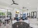 Spacious outdoor lounge with modern seating, fireplace, and multiple ceiling fans for year-round comfort at 10669 Cardera Dr, Riverview, FL 33578