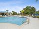Community pool with a sundeck, tables, playground, and an outdoor lounge area at 10669 Cardera Dr, Riverview, FL 33578
