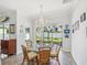 Charming dining room with a glass table, chandelier, and views of the backyard at 10669 Cardera Dr, Riverview, FL 33578