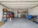 Spacious garage with ample storage shelves and a clean, well-maintained concrete floor at 10669 Cardera Dr, Riverview, FL 33578