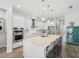 Modern kitchen features white cabinets, stainless steel appliances, and a large island with seating at 10669 Cardera Dr, Riverview, FL 33578