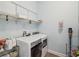 Bright laundry room equipped with modern washer and dryer, wire shelving and light blue walls at 10669 Cardera Dr, Riverview, FL 33578