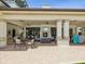 Inviting outdoor lounge area with fireplace, comfortable seating, and ceiling fans for relaxation at 10669 Cardera Dr, Riverview, FL 33578