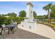 Built-in outdoor grill area with a striking chimney feature, perfect for outdoor dining and gatherings at 10669 Cardera Dr, Riverview, FL 33578