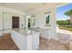 Well-equipped outdoor kitchen space with granite countertops, sink, and grill for easy entertaining at 10669 Cardera Dr, Riverview, FL 33578
