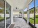 Extended covered patio featuring ceiling fan, dining area, and screened openings offering views of the fenced yard at 10669 Cardera Dr, Riverview, FL 33578