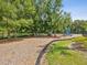 Community playground featuring play structures and shaded seating areas surrounded by lush greenery at 10669 Cardera Dr, Riverview, FL 33578