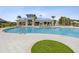 Gorgeous community pool with palm trees and clubhouse, offering a luxurious outdoor experience at 10669 Cardera Dr, Riverview, FL 33578