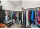 Well-organized walk-in closet with ample storage and rods for hanging clothes and shelving for shoes at 10669 Cardera Dr, Riverview, FL 33578