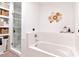 Bright bathroom featuring soaking tub and glass shower with built in laundry hampers and shelves at 111 N 12Th St # 1805, Tampa, FL 33602