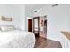 Bright bedroom featuring wood floors and an ensuite bathroom with toilet and built in shelves at 111 N 12Th St # 1805, Tampa, FL 33602