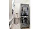 Conveniently designed laundry room with stacked washer/dryer and shelving for storage at 111 N 12Th St # 1805, Tampa, FL 33602