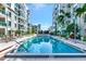Community swimming pool with lounge chairs surrounded by well manicured landscaping and multiple seating areas at 111 N 12Th St # 1805, Tampa, FL 33602