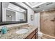 Updated bathroom featuring granite countertop, recessed lighting, and tiled walk-in shower at 11245 Bella Loma Dr, Largo, FL 33774