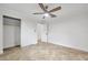An empty bedroom featuring an updated ceiling fan, tile floors, and a closet with access to another room at 11245 Bella Loma Dr, Largo, FL 33774