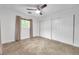 An empty bedroom featuring an updated ceiling fan, tile floors, and a closet with sliding doors at 11245 Bella Loma Dr, Largo, FL 33774