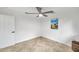 An empty bedroom featuring an updated ceiling fan, tile floors, and a painting of sailboats on the wall at 11245 Bella Loma Dr, Largo, FL 33774