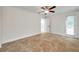 Spacious bedroom showcasing tile floors, a modern ceiling fan, and a window bringing in natural light at 11245 Bella Loma Dr, Largo, FL 33774