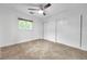 An empty bedroom featuring an updated ceiling fan, tile floors, and a closet with sliding doors at 11245 Bella Loma Dr, Largo, FL 33774