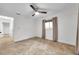 An empty bedroom featuring an updated ceiling fan, tile floors, and a window with curtains at 11245 Bella Loma Dr, Largo, FL 33774