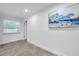 Bright bedroom featuring tile floors, fresh paint, a window, and an abstract art piece at 11245 Bella Loma Dr, Largo, FL 33774