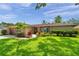 Charming single story home with a manicured lawn and colorful landscaping at 11245 Bella Loma Dr, Largo, FL 33774