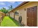 Exterior view of side of house, lawn, shed and water hose at 11245 Bella Loma Dr, Largo, FL 33774