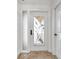 Front door with decorative glass and a matching sidelight, next to a storage closet at 11245 Bella Loma Dr, Largo, FL 33774