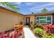 Front exterior featuring mature landscaping, a walkway to the front door, and a window at 11245 Bella Loma Dr, Largo, FL 33774