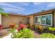 Landscaped front exterior featuring well-maintained yard, mulch beds, and flowering plants at 11245 Bella Loma Dr, Largo, FL 33774