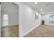 Neutral hallway features tile flooring, with openings into rooms featuring windows at 11245 Bella Loma Dr, Largo, FL 33774