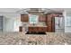 Modern kitchen boasts granite counters, stainless steel appliances, and sleek cooktop at 11245 Bella Loma Dr, Largo, FL 33774