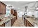 Spacious kitchen with granite countertops, stainless appliances, and lots of storage at 11245 Bella Loma Dr, Largo, FL 33774