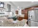 A modern kitchen featuring granite countertops, stainless appliances, and decorative fixtures at 11245 Bella Loma Dr, Largo, FL 33774