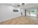 Spacious living area features tile flooring and sliding glass doors to a screened lanai at 11245 Bella Loma Dr, Largo, FL 33774