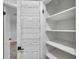 Custom pantry featuring adjustable shelving and door rack, maximizing storage space at 11245 Bella Loma Dr, Largo, FL 33774