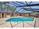 Relaxing screened-in pool with neutral-colored brick pool deck and access to the yard at 11245 Bella Loma Dr, Largo, FL 33774