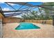 Backyard view of screened-in pool and brick-paved patio, complete with chairs and metal wall decor at 11245 Bella Loma Dr, Largo, FL 33774