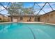 Backyard screened pool with brick patio and yard at 11245 Bella Loma Dr, Largo, FL 33774