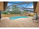 A backyard pool with brick patio is screened with a black aluminum structure at 11245 Bella Loma Dr, Largo, FL 33774