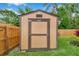 Exterior backyard view of storage shed with green grass and tropical plants at 11245 Bella Loma Dr, Largo, FL 33774