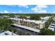Scenic aerial view of a low rise condo building with mature landscaping and covered parking at 11620 Park Blvd # 306, Seminole, FL 33772