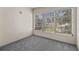 Sunny bedroom featuring carpet and large window overlooking the outdoor area at 11620 Park Blvd # 306, Seminole, FL 33772