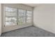 Bright, carpeted bedroom featuring ample natural light from the large window at 11620 Park Blvd # 306, Seminole, FL 33772
