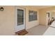 Inviting front entrance with neutral paint, storm door, and decorative welcome mat at 11620 Park Blvd # 306, Seminole, FL 33772