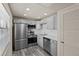 Modern kitchen with gray cabinets, stainless steel appliances, and recessed lighting at 11620 Park Blvd # 306, Seminole, FL 33772