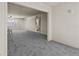 Spacious living room with new carpet, neutral walls and a view into the kitchen and bathroom at 11620 Park Blvd # 306, Seminole, FL 33772