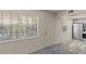 Cozy living room with two large windows allowing for ample natural light and a storm door for added security at 11620 Park Blvd # 306, Seminole, FL 33772