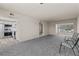 Open-concept living room featuring new carpet and view of kitchen with stainless steel appliances at 11620 Park Blvd # 306, Seminole, FL 33772